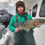 a person holding a fish