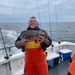 a man holding a fish in the water