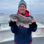 a person holding a fish in the water