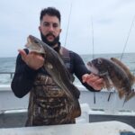 a man holding a fish