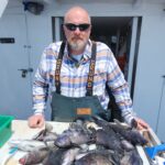 a man holding a fish