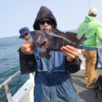 a man holding a fish