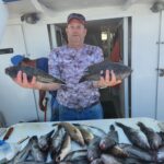 a man holding a fish