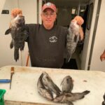 a man holding a fish