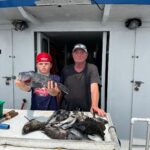 a man standing on top of a cutting board with a cake