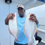 a man holding a fish