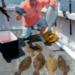 a man holding a fish in the water