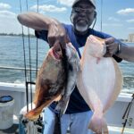 a man holding a fish in the water