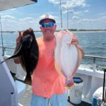 a person holding a fish on a boat in the water