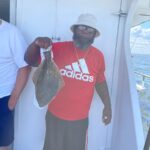 a man holding a fish