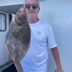 a man holding a fish
