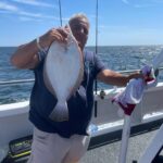 a person holding a fish in the water
