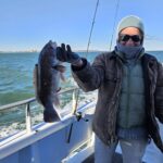 a person holding a fish on a boat