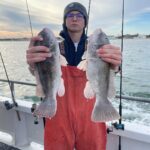 a person holding a fish in the water