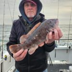 a man holding a fish
