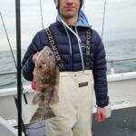 a person holding a fish on a boat