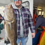 a man holding a fish