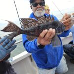 a man holding a fish