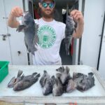 a man standing in front of a mirror posing for the camera