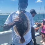 a man holding a fish