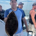 a man holding a fish