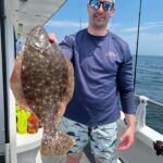 a man holding a fish