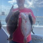 a man holding a fish
