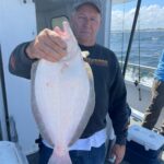 a man holding a fish