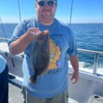 a man holding a fish in the water