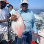 a man holding a fish