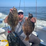 a man holding a fish in the water