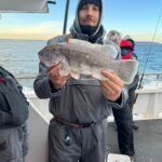 a man holding a fish in the water