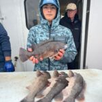 a person holding a fish