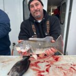 a man holding a fish