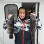 a man holding a fish