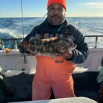 a man holding a fish in the water