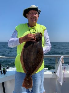 a man holding a fish in the water