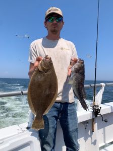 a man holding a fish in the water