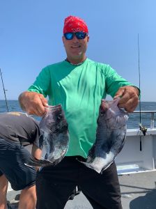 a man holding a fish