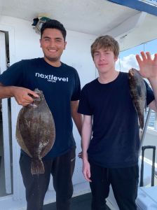 a man holding a fish posing for the camera