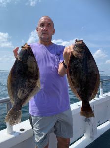 a man holding a fish