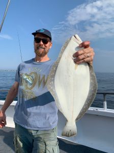 a man holding a fish in the water