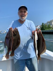 a man holding a fish in the water