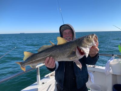 a person holding a fish in the water