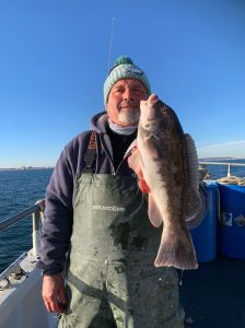 a man holding a fish