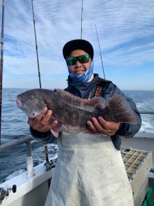 a man holding a fish in the water