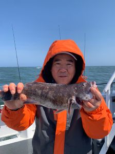 Fighting Harada holding a fish in the water