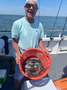 a man holding a fish on a boat