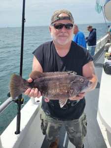 a man holding a fish in the water