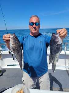 a man holding a fish in the water